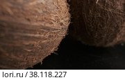 Three coconuts spinning on a black background close-up. Стоковое видео, видеограф Aleksey Kidisyuk / Фотобанк Лори