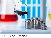 Laboratory scales with weights against test tubes. Стоковое фото, фотограф Сергей Толмачёв / Фотобанк Лори