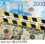 Денежные купюры: доллары и рубли. Оградительная лента с надписью "sanctions" Стоковое фото, фотограф Цибаев Алексей / Фотобанк Лори