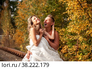 Young cute couple on their honeymoon woman and man embrace in their bed on railway tracks. Concept of romantic travel ban and inability to move. Stay at home. Copying space for a site. Стоковое фото, фотограф Aleksandr Golubev / Фотобанк Лори