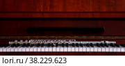 Flute with piano. Flute on piano keys. Wind instrument for musical design of concert creativity. Стоковое фото, фотограф Aleksandr Golubev / Фотобанк Лори