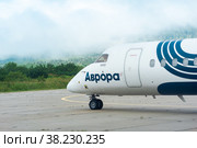 Aurora Airlines aircraft is ready for takeoff at the Mendeleevo airfield on the island of Kunashir (2022 год). Редакционное фото, фотограф Евгений Харитонов / Фотобанк Лори