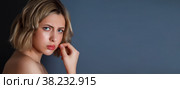 Advertising concept of discontent and severity. Close-up pretty portrait an angry discontented woman with hand at head against dark background. Female emotion scared and actress shows. Copy space. Стоковое фото, фотограф Aleksandr Golubev / Фотобанк Лори