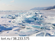 Beautiful winter landscape of frozen Lake Baikal on a January day. Ice hummocks of transparent blue snow-covered ice floes outside the village of Bolshoye Goloustnoye. Winter holidays and ice travel. Стоковое фото, фотограф Виктория Катьянова / Фотобанк Лори