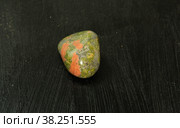Unakite pebbles green epidote natural mineral stone from Republic of South Africa RSA. Mineralogy, geology, magic of stones, semi-precious stones and samples of minerals. Close-up macro photo. Стоковое фото, фотограф Tae Mi / Фотобанк Лори