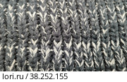 Knitted wool background made of melange yarn. Real texture of knitted fabric. Soft black and white wool macroshooting. Large knitting of woolen sweater. Background. Close-up. Вязаный шерстяной фон из меланжевой пряжи. Настоящая текстура трикотажного полотна. Макросъемка мягкой черно-белой шерсти. Крупная вязка шерстяного свитера. Фон. Крупный план. Стоковое фото, фотограф Ирина / Фотобанк Лори