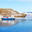 Frozen Baikal Lake. The Hivus hovercraft transports tourists across the Olkhon Gate Strait from Olkhon Island to the village of Sakhyurta. Cows graze on a coastal hill on a sunny cold day. Winter travel. Стоковое фото, фотограф Виктория Катьянова / Фотобанк Лори