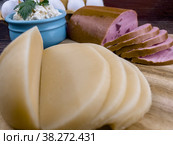 Sliced gastronomic products on a wooden table in close-up. Стоковое фото, фотограф Ярославский Максим / Фотобанк Лори