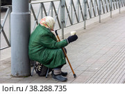 Krasnodar, Russia - February 11, 2020: grandmother asks for passers-by on the city sidewalk. Редакционное фото, фотограф Андрей С / Фотобанк Лори