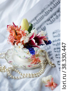 Cup with flower of tulips, muscari and hyacinths . Photo. Стоковая иллюстрация, иллюстратор Ирина Кротова / Фотобанк Лори