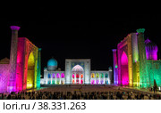 Tourists on Registan Square in Samarkand with Ulugbek Madrasah, Sherdor Madrasah and Tilla-Kari Madrasah at night during a color show. Uzbekistan (2019 год). Стоковое фото, фотограф Наталья Волкова / Фотобанк Лори