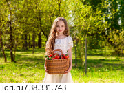 Cute smiling little girl holds basket  with tomatoes and cucumbers at the farm. Стоковое фото, фотограф Юлия Тарасова / Фотобанк Лори
