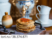Delicious pancakes with red caviar. Russian and Ukrainian cuisine. The concept of the Russian holiday Maslenitsa. Стоковое фото, фотограф Photojuli / Фотобанк Лори