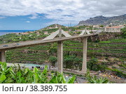 View of the Camara de Lobos in the foreground bridge over the Ribeira dos Socorridos. Madeira Island. (2012 год). Стоковое фото, фотограф Михаил Аккуратoв / Фотобанк Лори