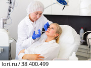 Cosmetologist doing botulotoxin injections for young woman. Стоковое фото, фотограф Яков Филимонов / Фотобанк Лори