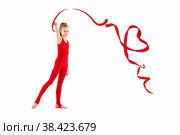 Slim gymnast in red overalls doing exercises with ribbon on white background, isolate. Стоковое фото, фотограф Мария Мороз / Фотобанк Лори