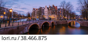 Amsterdam Netherlands canals with lights during evening in December during winter in the Netherlands. Стоковое фото, фотограф Fokke Baarssen / Фотобанк Лори