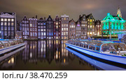 Amsterdam Netherlands canals with lights during evening in December during winter in the Netherlands. Стоковое фото, фотограф Fokke Baarssen / Фотобанк Лори