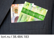 Banknotes of Norwegian krones sticking out of the business suit pocket. Стоковое фото, фотограф FotograFF / Фотобанк Лори