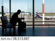 Россия. Санкт-Петербург. Пассажир ждет посадку в аэропорту Пулково. Инфраструктура авиационной промышленности. Пассажирские авиационные перевозки. Russia. Saint-Petersburg. A passenger is waiting for boarding at Pulkovo Airport. Infrastructure of the aviation industry. Passenger air transportation. (2021 год). Редакционное фото, фотограф Алексей Смышляев / Фотобанк Лори