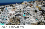 Oia village Santorini with whitewashed house and swimming pools Santorini Greece Europe. Стоковое видео, видеограф Fokke Baarssen / Фотобанк Лори