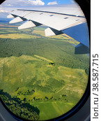 View of the Ground and the wing of the aircraft from the window of the aircraft. Russia, takeoff from Domodedovo airport. A beautiful landscape with a forest from the airplane window. Стоковое фото, фотограф Photojuli / Фотобанк Лори