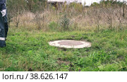 A man in overalls approaches a water well. Inspection of water meter readings. Стоковое видео, видеограф Коханова Наталья / Фотобанк Лори