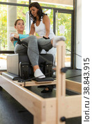 Positive activ hispanic female trainer controlling sports woman. Стоковое фото, фотограф Яков Филимонов / Фотобанк Лори