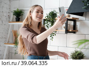 Happy young woman having video call, blogger webcast live online in the kitchen. Стоковое фото, фотограф Оксана Гильман / Фотобанк Лори
