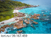 Aerial view of Seychelles tropical Marron beach at La Digue island. White sand beach with turquoise ocean water and quaint granite rocks. tropical paradise (2019 год). Стоковое фото, фотограф Igor Tichonow / Фотобанк Лори