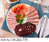 Slices of Spanish dry-cured gammon, variety of sausages. Стоковое фото, фотограф Яков Филимонов / Фотобанк Лори