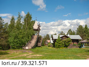 MANDROGI, RUSSIA - JUNE 8, 2015: Karelia Region, a new traditional-style resort in the old village of Mandrogi. The winter attraction is a wooden slide. Редакционное фото, фотограф Оксана Медведева / Фотобанк Лори