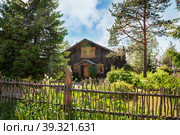 MANDROGI, RUSSIA - JUNE 8, 2015: Karelia Region, a new traditional-style resort in the old village of Mandrogi. Wooden house stylized in Russian traditions. Редакционное фото, фотограф Оксана Медведева / Фотобанк Лори