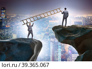 Business people helping to go over chasm. Стоковое фото, фотограф Elnur / Фотобанк Лори