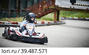 Karting. motorsport road racing with open-wheel four wheeled vehicles at go-karts. Стоковое фото, фотограф Дмитрий Калиновский / Фотобанк Лори