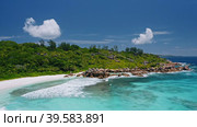 Aerial view of tropical paradise beach Anse Coco. Unrecognized tourists swimming in crystal clear blue lagoon. La Digue island, Seychelles. Стоковое видео, видеограф Igor Tichonow / Фотобанк Лори