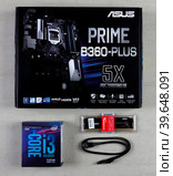 Maykop, Russia - November 9, 2018: Asus motherboard in box, intel I3 processor, Kingston Fury HyperX 16GB RAM and cable for connecting SATA 6gbs devices on grey background top view. Редакционное фото, фотограф Андрей С / Фотобанк Лори