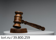 Brown wooden judge gavel on gray background. Стоковое фото, фотограф Сергей Толмачёв / Фотобанк Лори