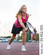 Young forcefully teenage girl playing tennis close to net on court. Стоковое фото, фотограф Яков Филимонов / Фотобанк Лори