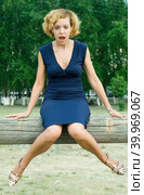 Surprised woman sitting on log. Стоковое фото, фотограф Сергей Буторин / Фотобанк Лори