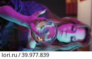 A young woman showing a performance with crystal ball in her hands. Стоковое видео, видеограф Константин Шишкин / Фотобанк Лори