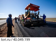 Kyzylorda province, Kazakhstan, April 29, 2012: Construction of West Europe-West China highway. Dynapac road machine and asphalt layers. Стоковое фото, фотограф Alexey Rezvykh / Фотобанк Лори