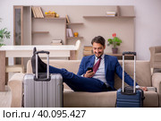 Young businessman preparing for trip at home. Стоковое фото, фотограф Elnur / Фотобанк Лори
