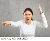 Woman argues while pointing accusingly with fury and anger. Стоковое фото, фотограф Яков Филимонов / Фотобанк Лори