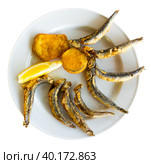 Dish with fried sardines, pilchards or anchovies in batter for traditional Spanish meal. Стоковое фото, фотограф Яков Филимонов / Фотобанк Лори