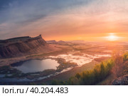 Panorama panoramic landscape nature mountains sunrise sunset of Chest butte or First Sunduk against blue sky. Sunduki mountain range from Devonian sandstone stone located in the valley of the Bely Iyus River in Khakassia, Russia. Стоковое фото, фотограф Владимир Разгуляев / Фотобанк Лори