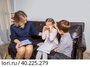 Girl psychologist calms upset girl. The kid is crying. Стоковое фото, фотограф Юрий Поздников / Фотобанк Лори