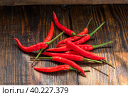 Pile of thai Bird's Eye Chilis on a old wooden table. Стоковое фото, фотограф Всеволод Белоусов / Фотобанк Лори