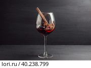 Бокал с красным вином, гроздьями винограда, долькой апельсина и пряностями на старом темном столе. Вино и виноделие. Алкоголь. Малая глубина резкости. Стоковое фото, фотограф Андрей Пустякин / Фотобанк Лори