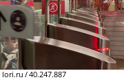 Passengers pass through the turnstiles in the Moscow metro to the station in the morning. Moscow. Kuzminki station. March 28, 2023. Стоковое видео, видеограф Ярославский Максим / Фотобанк Лори